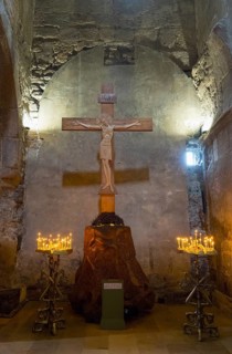 Interior of a church with a wooden cross and candlesticks on both sides, intimate religious