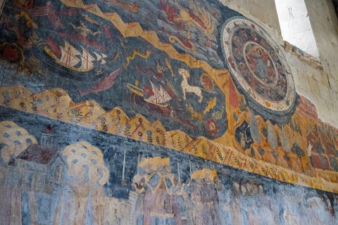 Wall painting with mythological themes, including ships and a lion in medieval style,