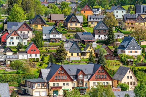 Residential buildings with black roofs and wooden and slate facades, Seiffen health resort and toy