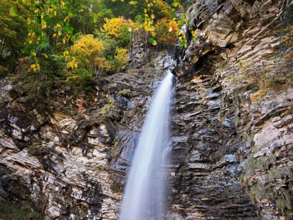 Diesbach waterfall in autumn-colored surroundings, Linthal, Klausenpass, Canton of Glarus,