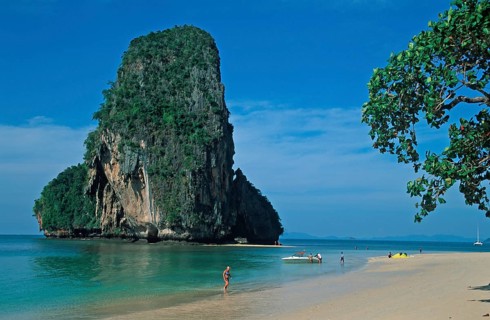 Rocks in the sea, tree, boat and people on Pranang Cave beach, two years in front of the tsunami,