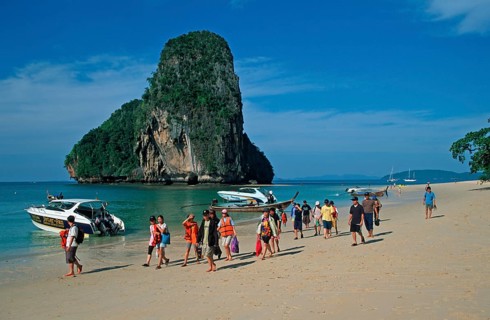 Rocks in the sea, boats and people on Pranang Cave beach, two years in front of the tsunami, Krabi,
