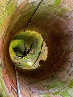 View down into well shaft from 176 meters deep deepest castle well in the world Fountain of