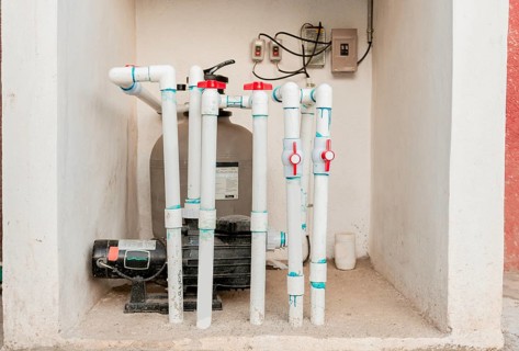 Pool pump with sand filter installed. Pool purification and maintenance system. Home pool filter
