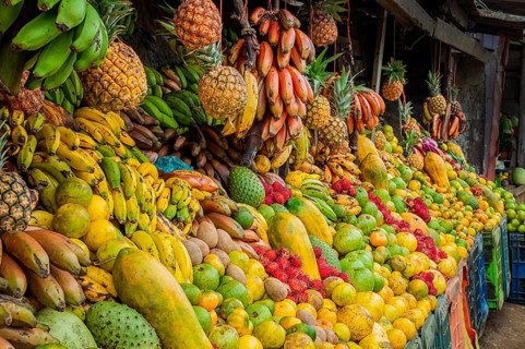 Shelf of many fresh fruits, fresh fruit stall, concept of fruits and healthy food, sale of various