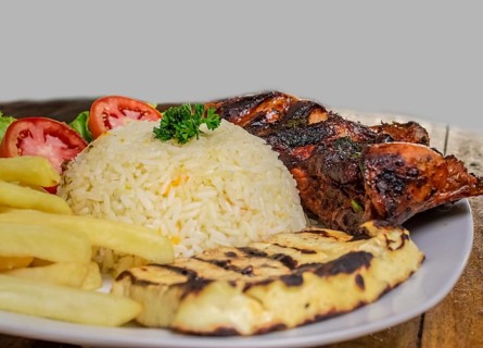 Pork rib with rice, fried cheese and salad served on the table, Close up of Pork rib with salad and