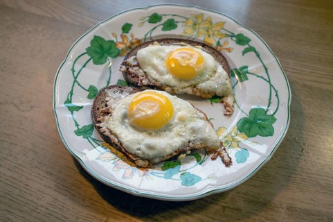 Two fried eggs served on bread on a plate, Bavaria, Germany