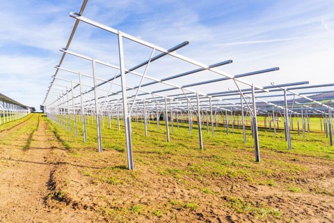 Metal framework on a field under a blue sky for solar systems, energy revolution, construction of