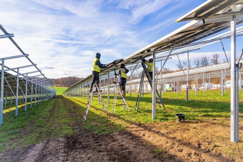 Workers install solar panels on a sunny day, Energiewende, construction of PV open space,