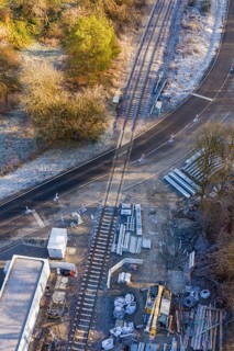 Construction site on a railway line with building materials next to a road, construction of the