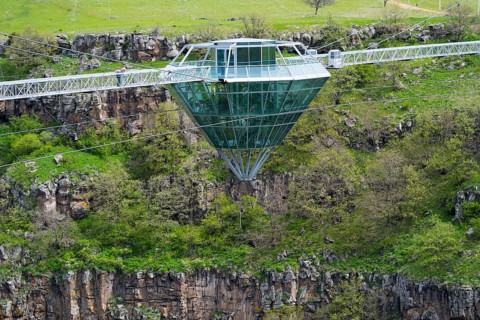 Modern glass bridge crosses green gorge with trees and rocks, diamond bridge, Diamond Glass Bridge,