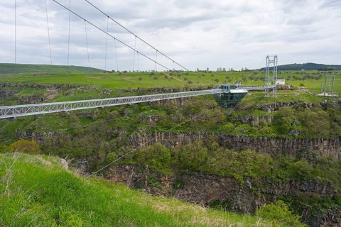 Long glass bridge spanning green landscape and gorge, diamond bridge, Diamond Glass Bridge, world's