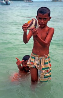 Two boys with a tropical fish on Ko Phi Phi Don, two years in front of the tsunami, Thailand,