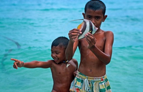 Two boys with a tropical fish on Ko Phi Phi Don, two years in front of the tsunami, Thailand,