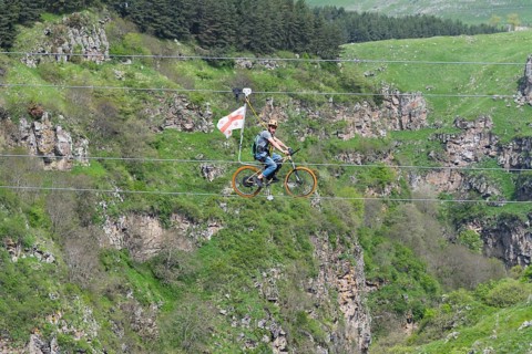 Adventurous bicycle ride on a rope through a distinctive rocky landscape, Dashbashi Gorge, Khrami