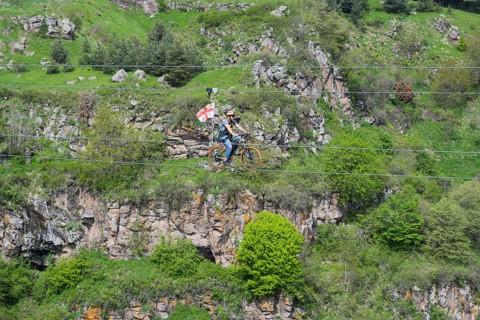 A bicycle ride on a rope leads across a rocky, green gorge, Dashbashi Gorge, Khrami River, Tsalka