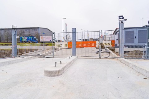 Closed construction site with concrete floor in an industrial environment, parking garage
