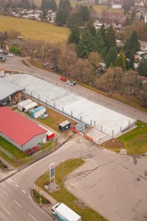 Urban aerial view with parking lot, roads and surrounding buildings, parking garage construction