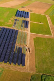 Bird's-eye view of solar panels on green fields in a rural area, Energiewende, construction of PV