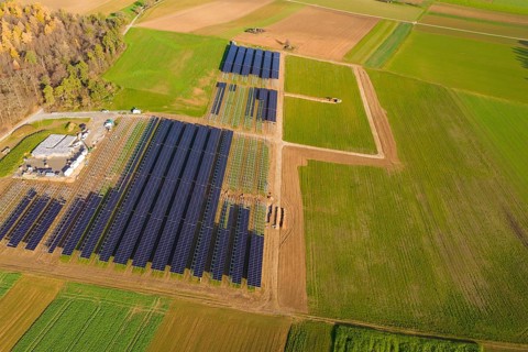 Extensive solar system in the midst of green and autumnal fields from the air, energy revolution,