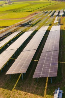 Close-up of solar cells on green fields under bright sky, Energiewende, construction of PV open