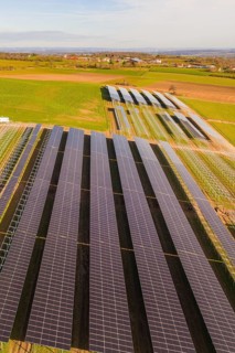 Rows of solar systems on green fields under clear skies, Energiewende, construction of PV open