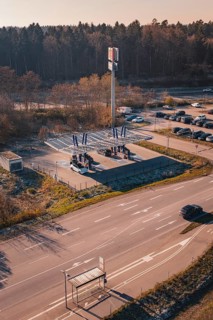 Charging station with electric car near a forest, quiet surroundings with sunset and autumn flair,