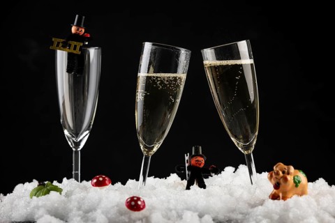 Champagne glasses filled with lucky charms for New Year in the snow