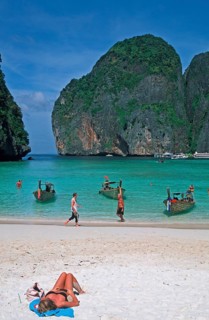 People, longtail boats on Maya Bay beach, known from the movie The Beach, one year in front of the