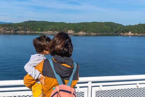 Mother and child enjoying the scenic ocean view from a ferry deck on the journey from victoria to