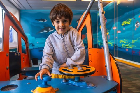 Young boy enjoying playing captain on a ferry boat traveling from victoria, vancouver island, to