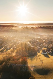 Sun-drenched settlement in fog with landscape view at sunrise, Gechingen, Calw district, Germany