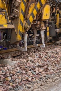 Close up of a construction machine used for track work on gravel, tamping machine on Hermann,