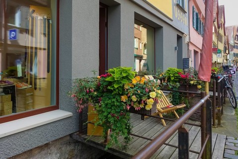 Shop entrance at the Ammer, floral decoration, typical scene, shopping street, planter with various