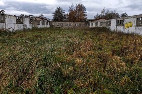 Dilapidated halls of the dilapidated plant of a former agricultural production cooperative of the