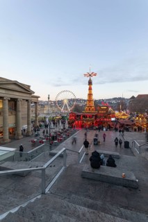 Stuttgart 2025 Christmas market on Schlossplatz with festive lights, a Christmas pyramid, mulled
