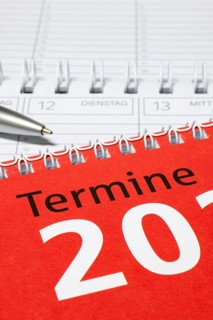 Red calendar with silver pen and spiral binding, diary