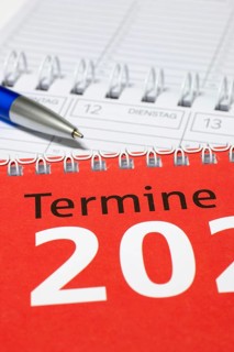 Vertical photographed calendar with blue pen and red cover, diary