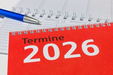 2026 calendar with red cover, blue pen and spiral binding, diary