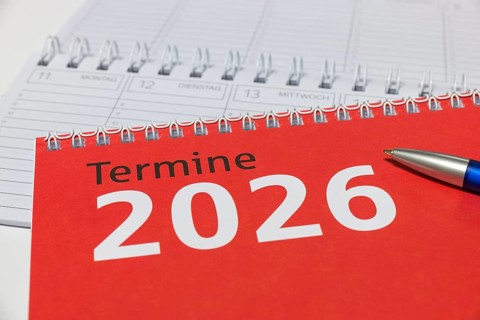 Red calendar for 2026 with blue pen on spiral binding