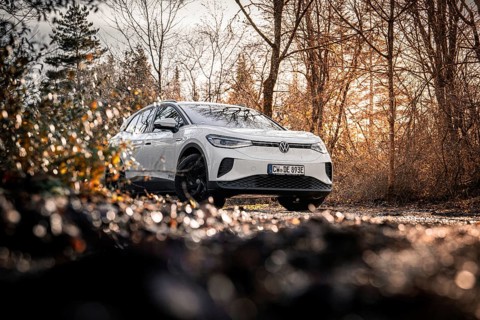 Car in an autumn forest landscape with bare trees, VW ID4 electric car, Deer Carsharing, Calw,
