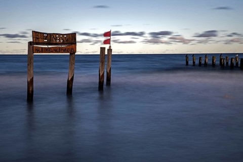 Wooden sign in the sea with inscription Zingst and Buhnen, long exposure, evening light, Zingst,