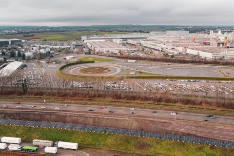 Extensive Daimler Benz industrial area with roads and parking lots under a cloudy sky, Böblingen,