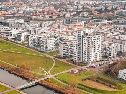 Residential complexes next to a river with a bridge in an urban area, Böblingen airfield, Germany