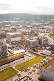 New hospital building Municipal construction site with several buildings and cranes next to green