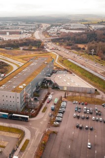 View from above of an industrial area with parking spaces next to a busy motorway, Böblingen,