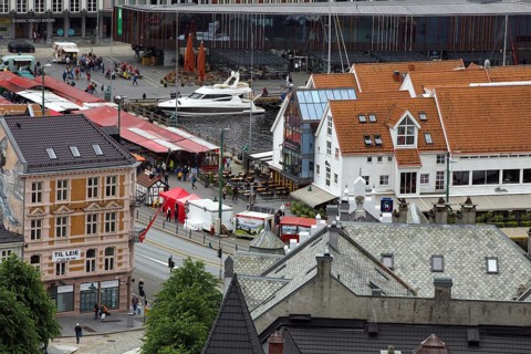Urban scene with a marketplace, boats and surrounding buildings, Bergen Norway