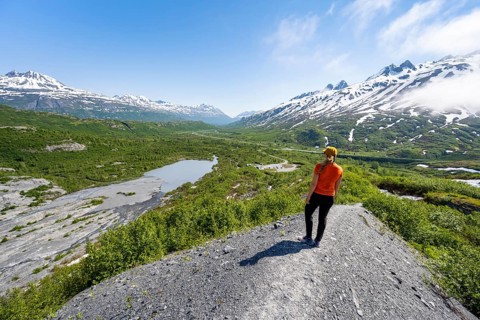 Female hiker on glacial moraine, view of the vast Tsina River valley with mountains, Worthington