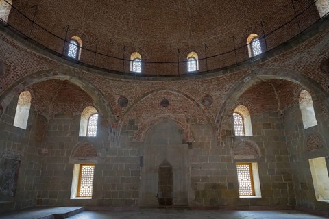 Historic interior with brick dome and windows that diffuse soft light into the room, Rabati
