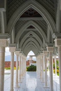Detailed view of a vaulted corridor with intricately carved stone columns and arches, Rabati